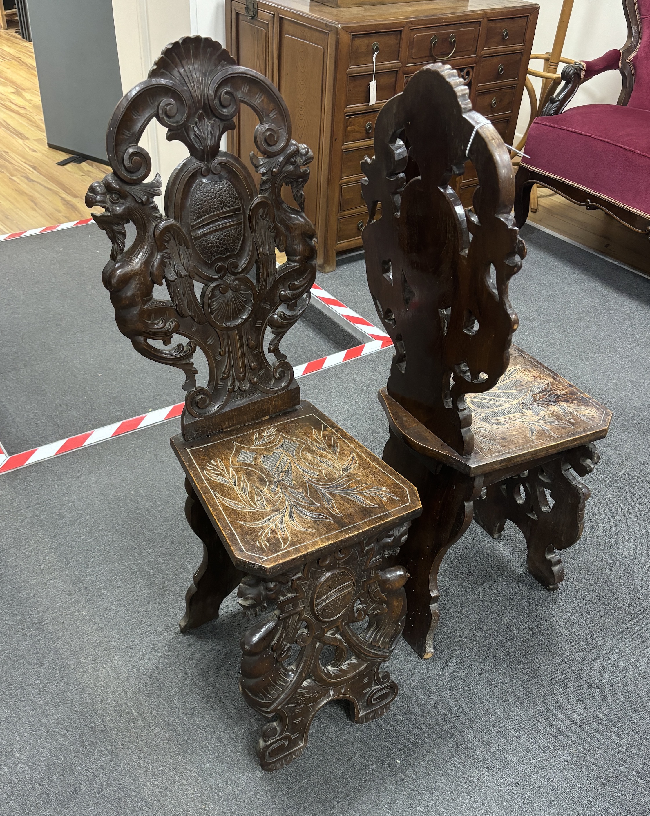 A pair of 18th century style carved walnut hall chairs, width 36cm, depth 27cm, height 106cm